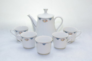 Mock up / design set of elegant and traditional teapot colorful white and blue coffee cup & Tea cup on cup's plate beside the hot tea pot , design/ drink-ware isolated on white background