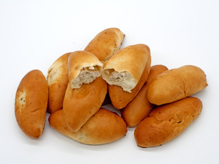 The oval beautiful Russian pie is divided into two parts, the filling is visible. White background