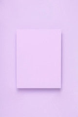 Obraz na płótnie Canvas Minimal frame geometric composition mock up. Blank sheet of lilac paper postcard on delicate blue background. Template design invitation card. Top view, flat lay, copy space.
