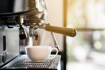 Professional photos of coffee machines that are filling coffee into a cup.