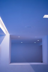 Interior of modern architecture in Latin American capital, open spaces with white walls, artificial lighting and design of vanguard.