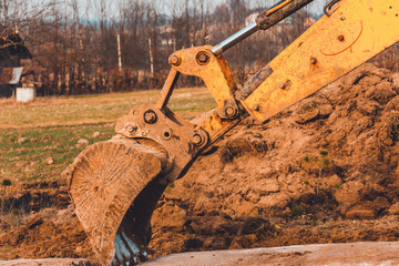 The excavator moves the concrete slabs to set the road in private territory.