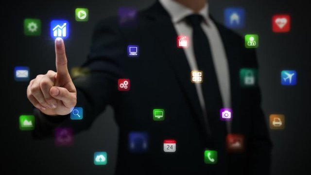 Businessman working on holographic interface. Financial. Multicolored. Businessman drawing a bright arrow showing increasing profits in a financial chart. Business success.