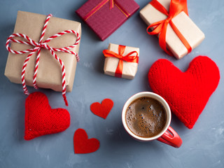 Valentine's day gifts and red hearts symbolizing love. a Cup of coffee on the table