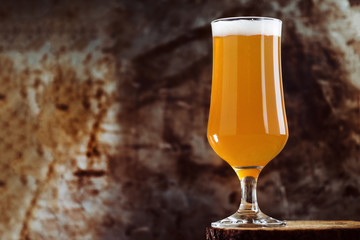 A glass of craft beer ale IPA on a rusty dark background