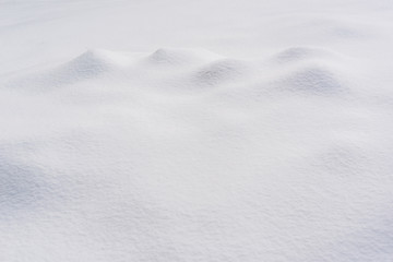 Textured surface covered with clear white snow