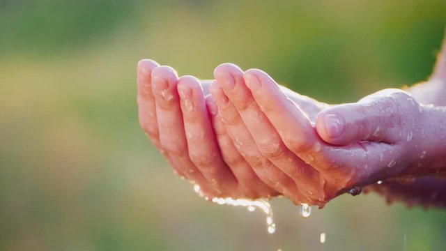 A man tries to hold water in his palms