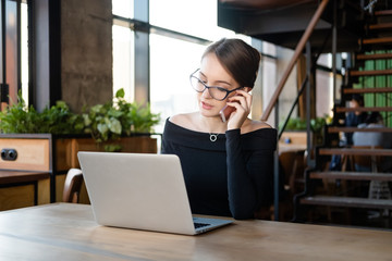 businesswoman working on laptop in cafe