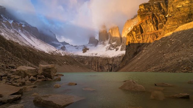 Time lapse view of sunrise over the iconic granite towers at Mirador Las Torres in Torres del Paine National Park, Patagonia, Chile.