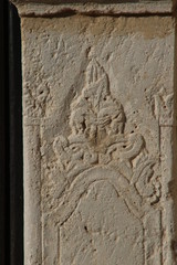 Texture of old stone from the sun lit facade of a medieval church in Crete