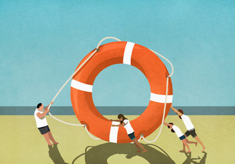 Family pulling and pushing large life ring on beach