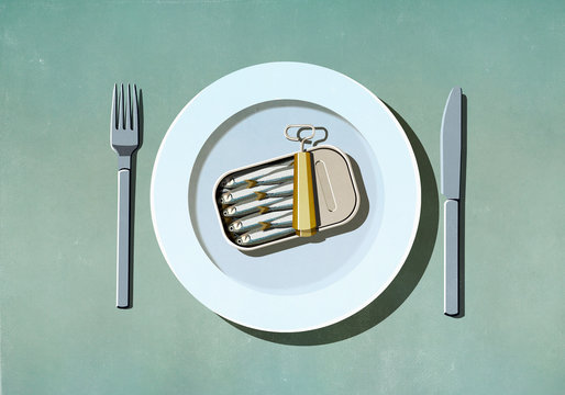 Can of sardines on plate