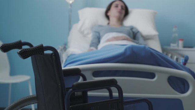 Woman lying in the hospital bed and getting IV therapy