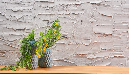 Decorative textured grey stone wall, wooden desk and frame, home ornament detail.