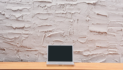 Decorative textured grey stone wall, wooden desk and frame, home ornament detail.