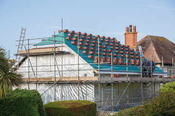 Small stacks of tiles on a roof ready for installing during the construction of a new house.