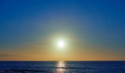 Atlantic ocean and the sun in cloudless sky