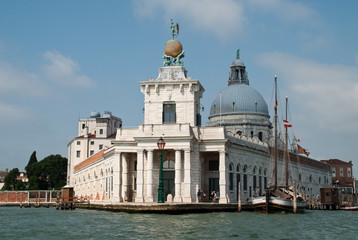 Fototapeta na wymiar Venice, Italy: the Dogana building, (Punta della Dogana), Church Santa Maria della Salute behind it