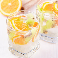 Summer refreshing non alcoholic cocktails with orange and kiwi fruits closeup still life. Summer mocktail with citrus and sparkling water, healthy lifestyle concept
