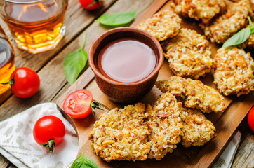 almond crusted chicken tenders with ketchup on a wood background