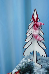 wooden christmas tree with red toys on blue background