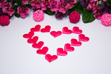 Heart made of hearts on a white background with copy space. Pink flowers. Valentine's Day