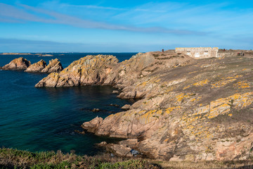 The rocky coastline of Beg er Vachif peninsula in west of Houat island in French Brittany. Ruins of Beniguet bastion are at right.