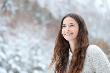Candid teen watching snow in the mountain in winter