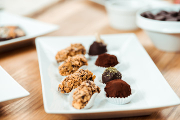 selective focus of chocolate truffles and tasty candies on plate