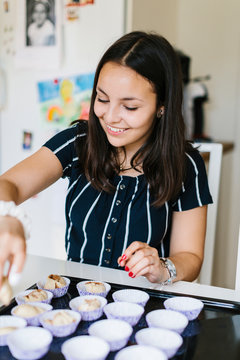 Teenage girl baking in kitchen