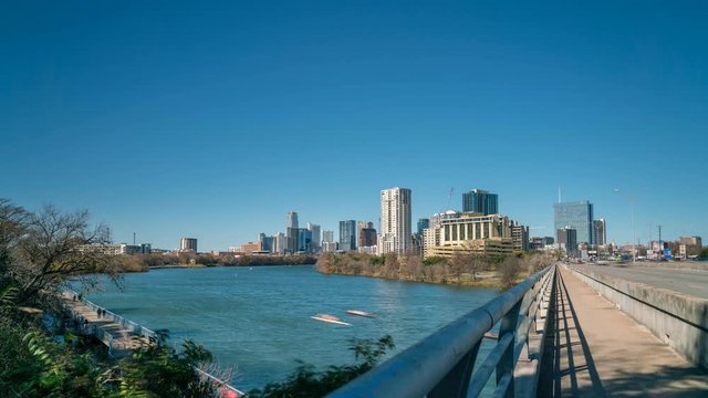 Time Lapse of People Running and Rowing on Lady Bird Lake With Downtown Austin Skyline in the Background