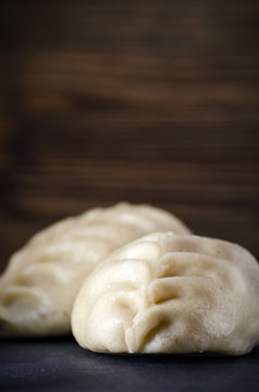 pyanse, korean pies on a stone board, korean national food pigodi on a dark background