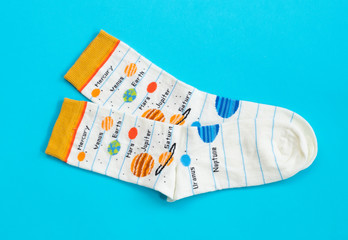 two multi-colored socks on a blue background, concept