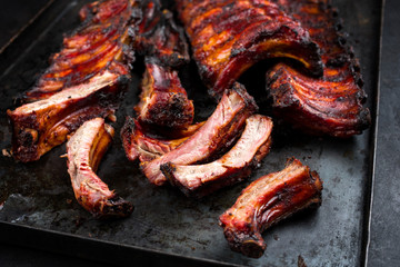 Barbecue pork spare ribs St Louis cut with hot honey chili marinade as closeup on an old rustic...