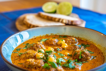 Top view of a delicious soup with meatball and herbs 