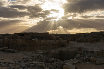 Dramatic sky and sun rays above ancient Giza graveyard