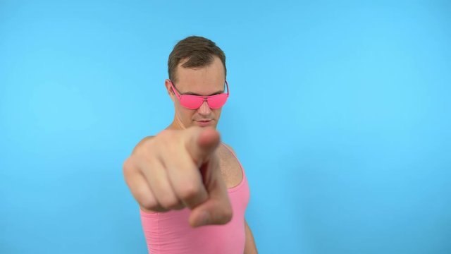 crazy man in pink glasses come here gesture on blue background