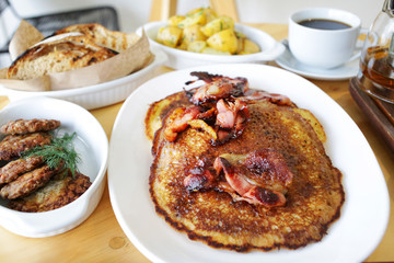 Delicious bacon pancakes breakfast with coffee at the table