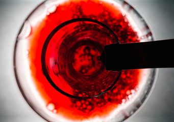 Red wine pouring in decanter