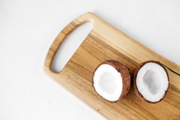 Tasty juicy coconut on a wooden board. Food concept.
