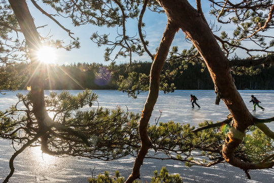 Ice skaters on frozen lake