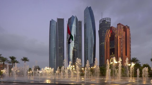 Etihad Towers viewed through the fountains of the Emirates Palace Hotel, Abu Dhabi, United Arab Emirates, Middle East