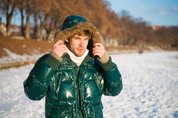 nature is beautiful. place for thoughts. cold and loneliness. male in down coat with fur hood. feel warm and comfortable. favorite season. environment concept. man enjoy winter landscape