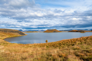The lake of Myvatn is surrounded by mountains with a beautiful sky