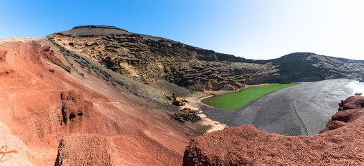 Majestic panorama of volcanic green lake (El Lago Verde), black sand beach and the eroded volcano...