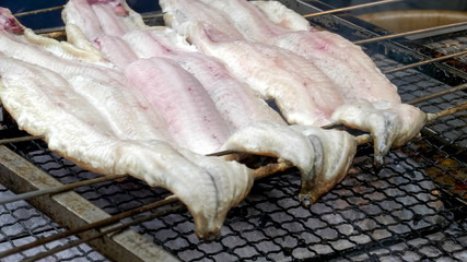 close up of fish being grilled by a vendor outside fushimi inari shrine