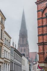 Fototapeta na wymiar Clock tower of Schwerin Cathedral with heavy fog in Schwerin near Hamburg, Germany