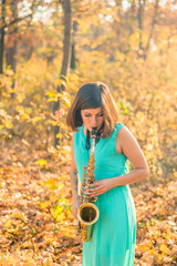 beautiful young girl with black hair and a tattoo on her arm, dressed in a long blue dress and...