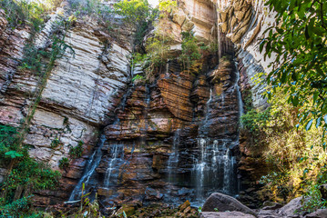 Water stream sliding down over rocky cliff in Brazil