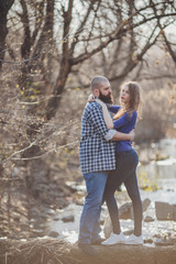 A girl and a guy are walking in the park. Portrait of a couple, a love story.Happy smiling, loving couple together outstretched at beautiful nature.